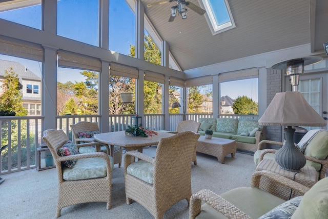 sunroom / solarium with lofted ceiling with skylight, a wealth of natural light, and ceiling fan