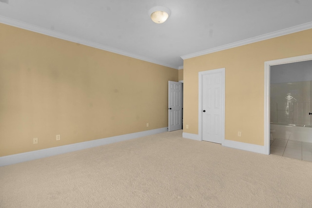 unfurnished bedroom featuring connected bathroom, crown molding, and light colored carpet