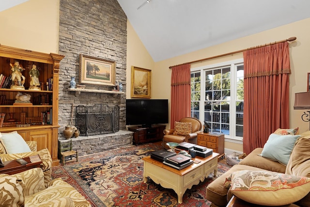 living room with a stone fireplace and high vaulted ceiling