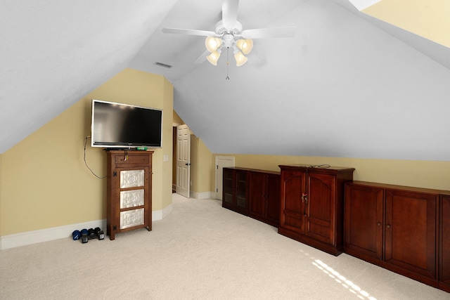 bonus room with vaulted ceiling, light colored carpet, and ceiling fan