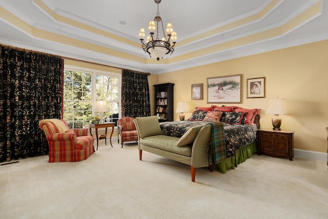 carpeted bedroom featuring a raised ceiling, ornamental molding, and a chandelier