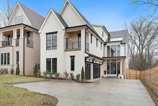 rear view of house with a balcony and a garage