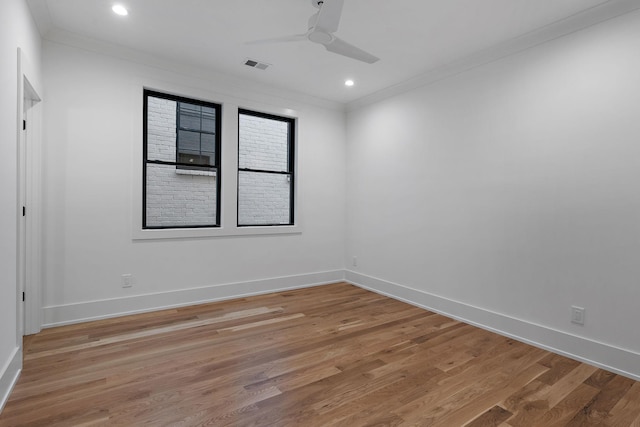 spare room with ceiling fan, ornamental molding, and light wood-type flooring