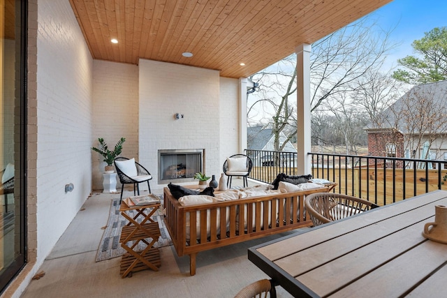 exterior space with an outdoor living space with a fireplace