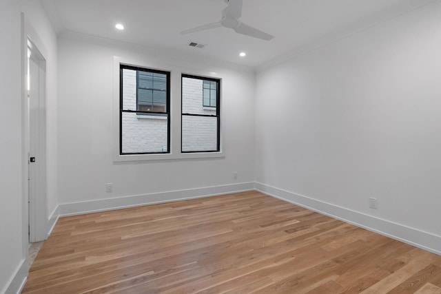 spare room with ceiling fan, ornamental molding, and light hardwood / wood-style floors