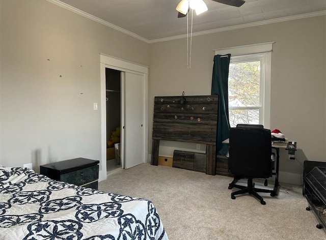 bedroom with crown molding, carpet floors, a closet, and ceiling fan