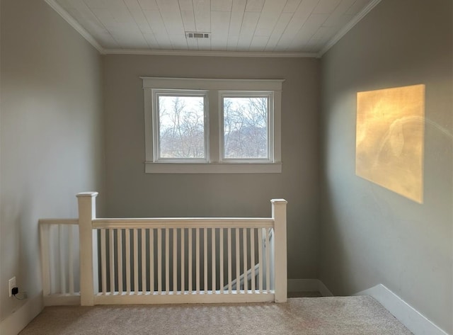 interior space with ornamental molding and carpet flooring