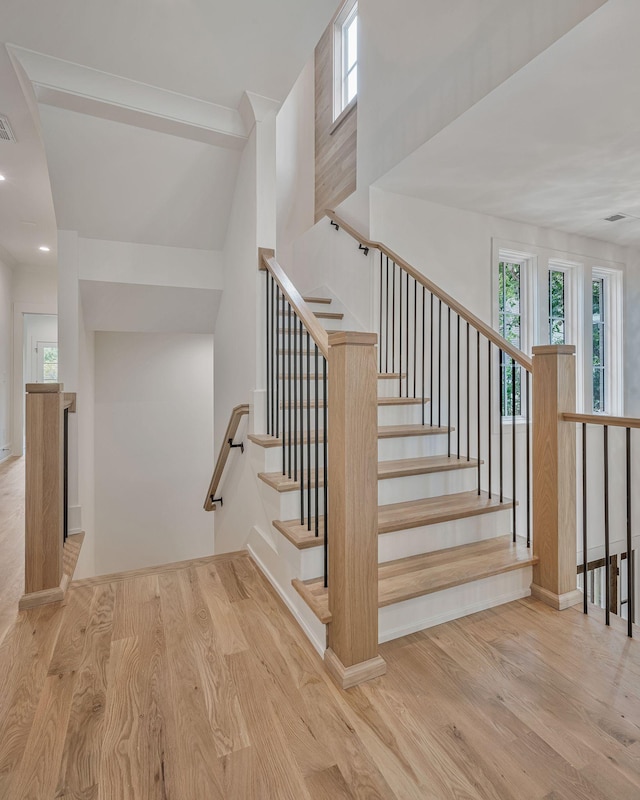 stairs featuring hardwood / wood-style flooring