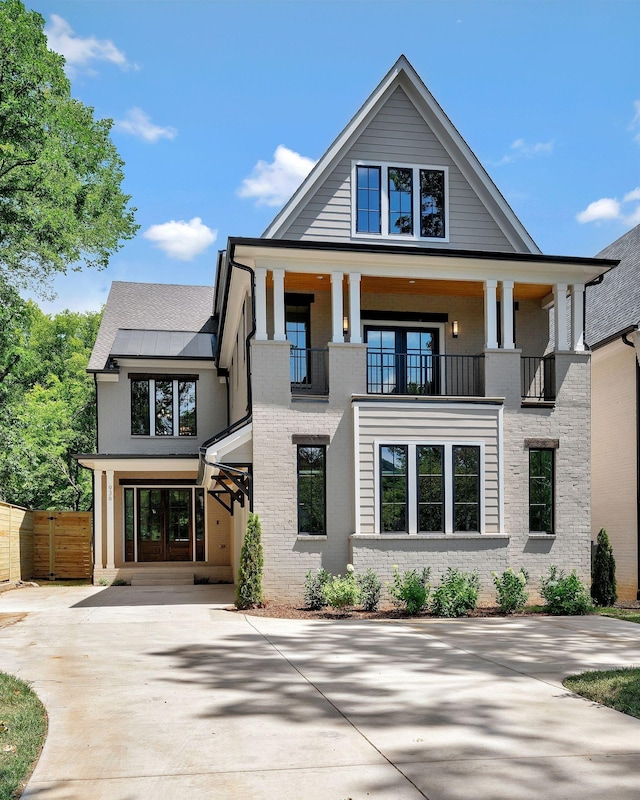 view of front of property with a balcony and french doors