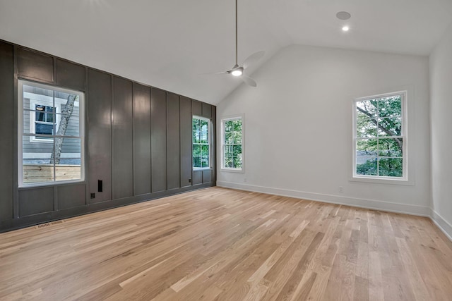 interior space featuring ceiling fan, high vaulted ceiling, and light wood-type flooring