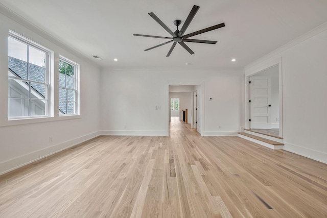 spare room featuring crown molding, light hardwood / wood-style flooring, and ceiling fan