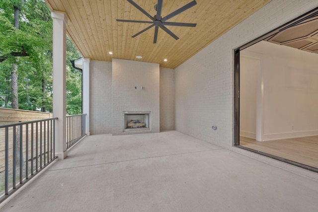 view of patio / terrace with a large fireplace and ceiling fan