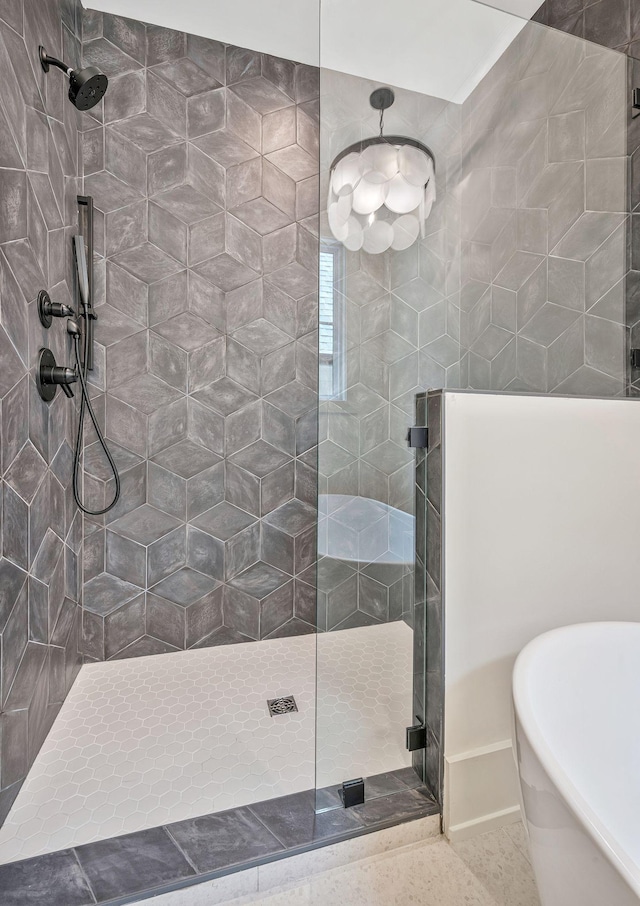 bathroom featuring shower with separate bathtub