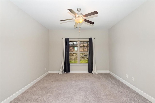 unfurnished room with light colored carpet and ceiling fan