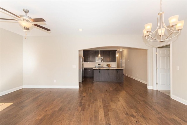 unfurnished living room with dark hardwood / wood-style floors and ceiling fan with notable chandelier