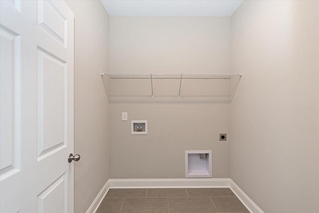 laundry area with dark tile patterned floors, washer hookup, and hookup for an electric dryer