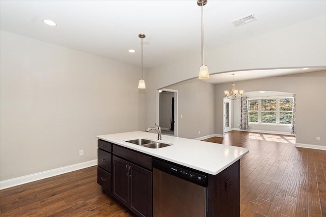 kitchen featuring sink, dark wood-type flooring, hanging light fixtures, a center island with sink, and stainless steel dishwasher