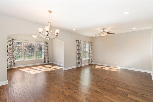 unfurnished room featuring dark wood-type flooring and ceiling fan with notable chandelier