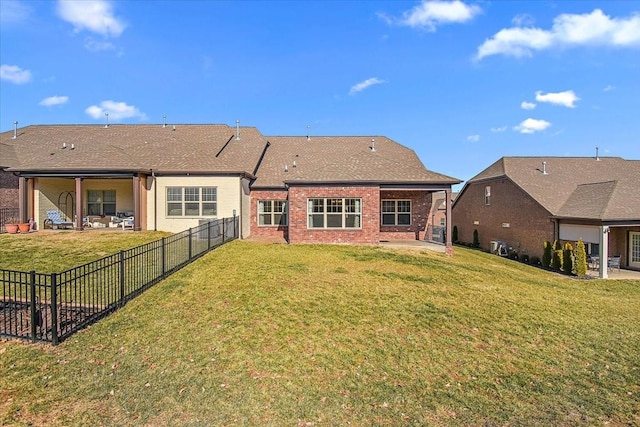 back of house featuring a patio and a lawn