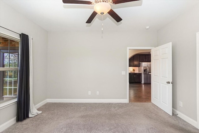 unfurnished room with carpet floors and ceiling fan