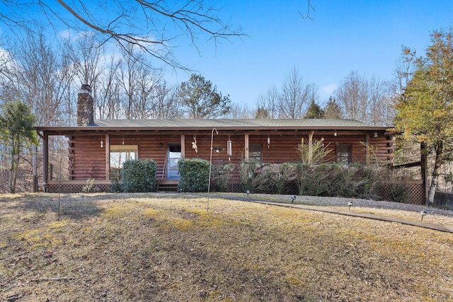 log cabin featuring a front yard