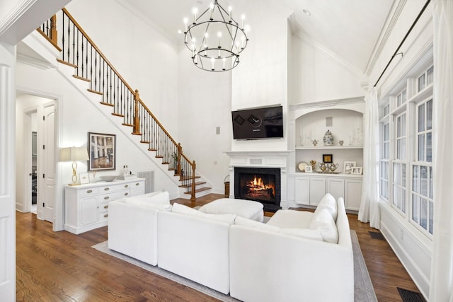 living room featuring crown molding, dark hardwood / wood-style floors, a chandelier, and high vaulted ceiling