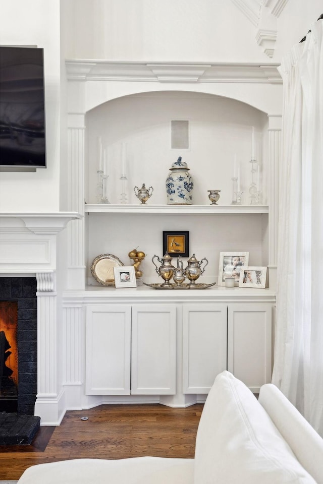 bar featuring white cabinets, dark hardwood / wood-style flooring, and built in shelves