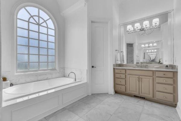 bathroom with vanity and a bath