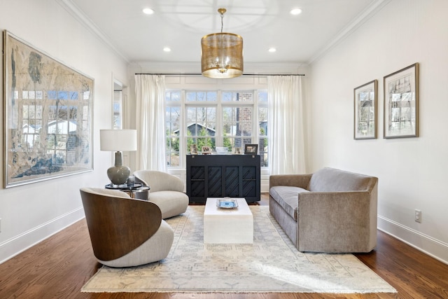 sitting room with ornamental molding and hardwood / wood-style floors