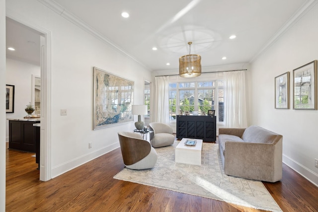 living area with crown molding and dark hardwood / wood-style floors