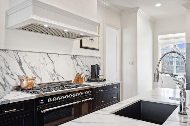 kitchen with sink, light stone counters, ornamental molding, custom range hood, and range with two ovens