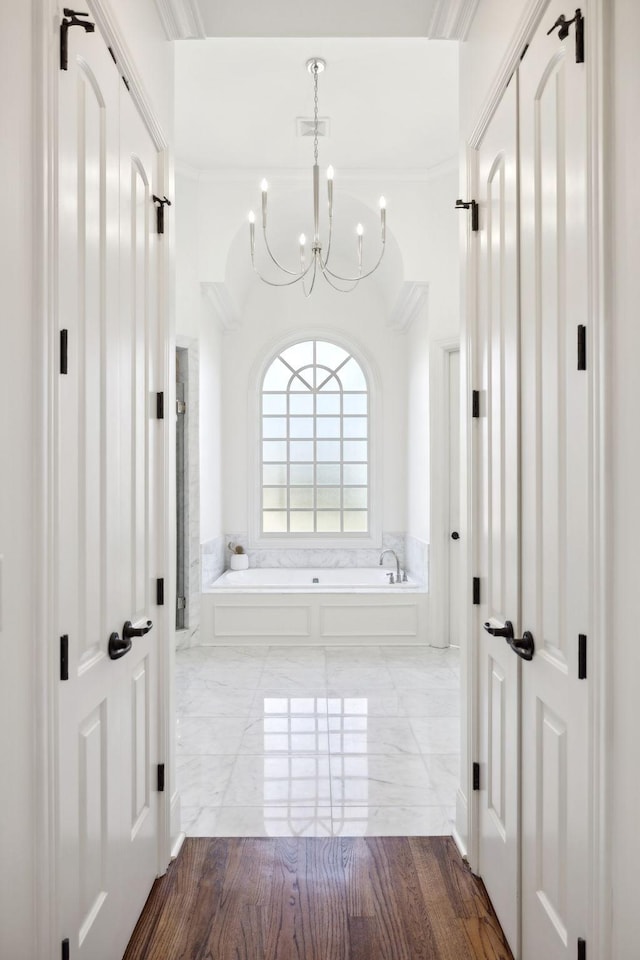 hallway with a chandelier