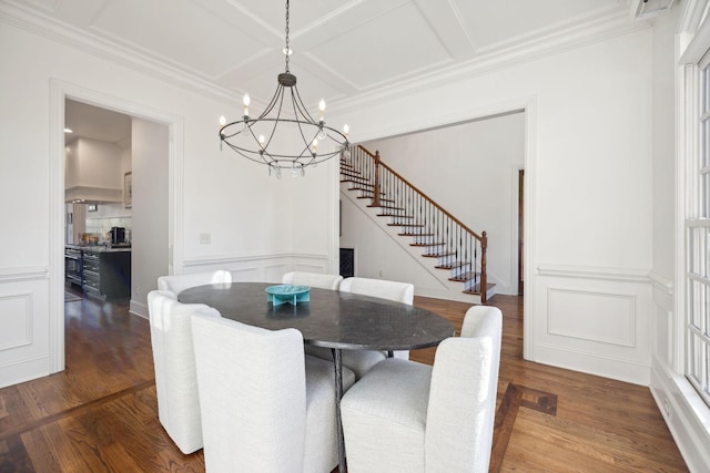 dining room featuring coffered ceiling, hardwood / wood-style flooring, ornamental molding, and an inviting chandelier