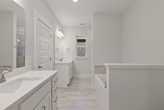 bathroom featuring vanity and shower with separate bathtub