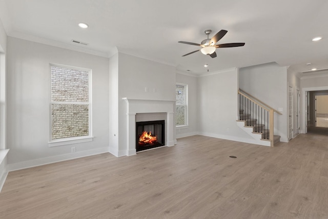 unfurnished living room with ornamental molding, ceiling fan, and light hardwood / wood-style floors