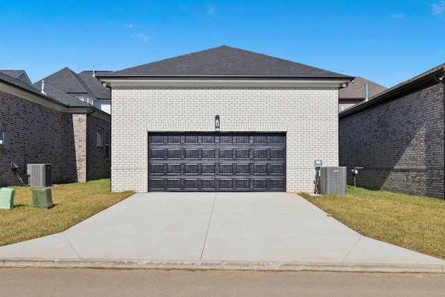 exterior space featuring cooling unit, a garage, and a yard