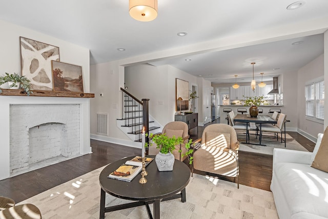 living room featuring a fireplace and wood-type flooring