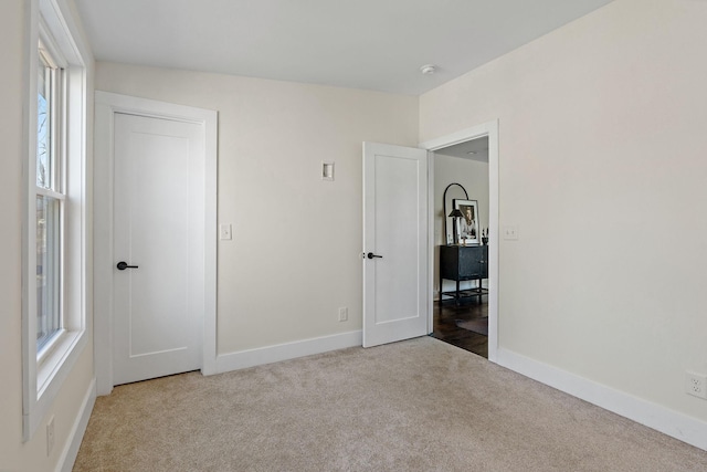 unfurnished bedroom with light colored carpet