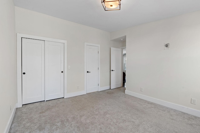 unfurnished bedroom featuring light carpet