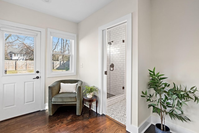 sitting room with dark wood-type flooring