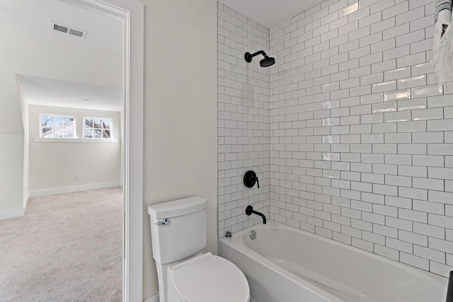 bathroom featuring toilet and tiled shower / bath combo