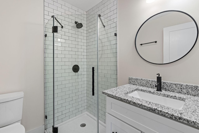 bathroom featuring vanity, toilet, and walk in shower