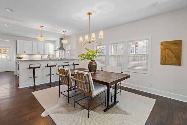 dining area featuring a notable chandelier and dark wood-type flooring