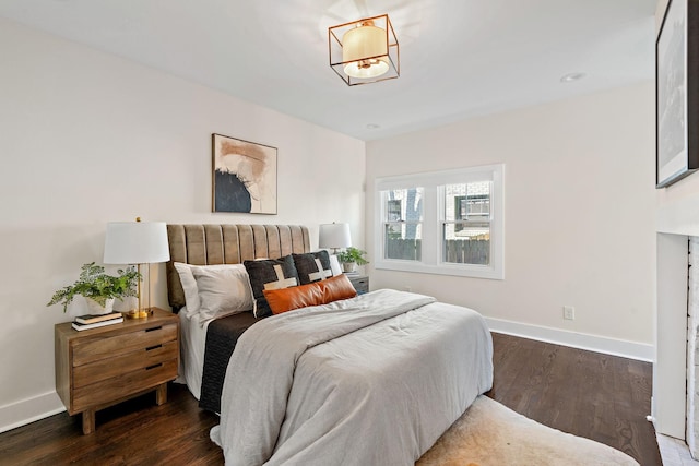 bedroom with dark hardwood / wood-style flooring