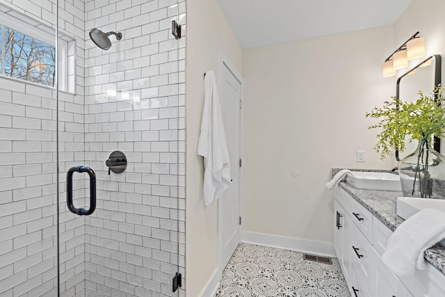 bathroom with tile patterned floors, vanity, and a shower with door