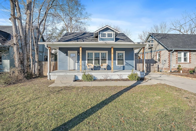 bungalow with a front lawn and covered porch