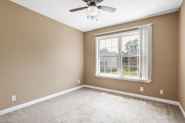 carpeted empty room with ceiling fan