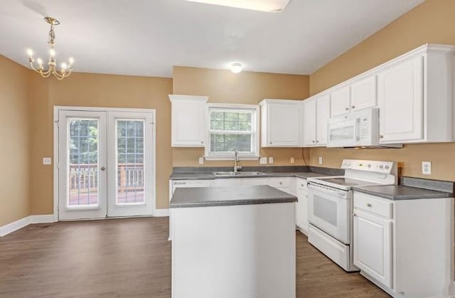 kitchen featuring white cabinetry, white appliances, pendant lighting, and a kitchen island