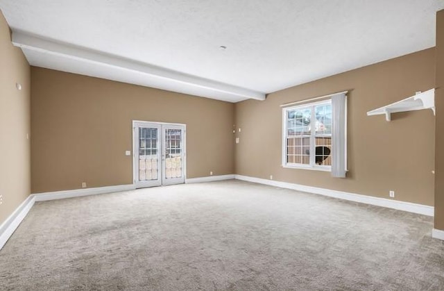 carpeted spare room with beamed ceiling