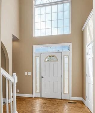 foyer featuring light hardwood / wood-style floors and a high ceiling